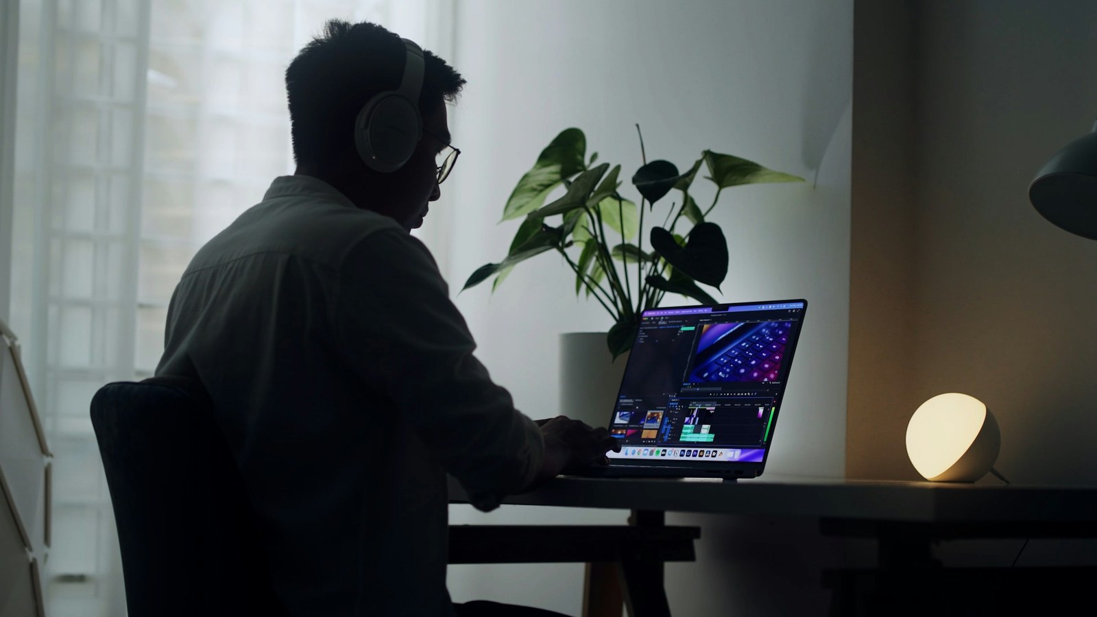 A developer working at a clean desk with a laptop in a modern workspace, representing how an AI gateway sits between applications and AI models